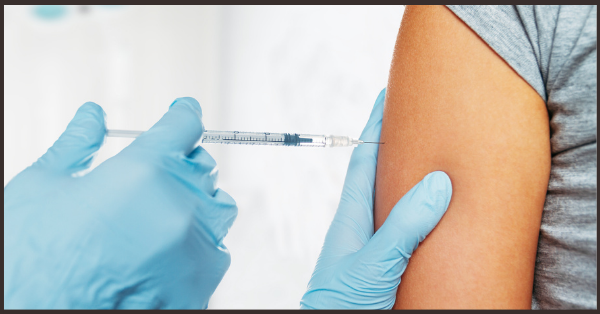 A person getting a shot in the arm