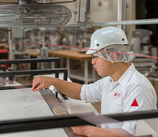 Woman cleaning bakery equipment