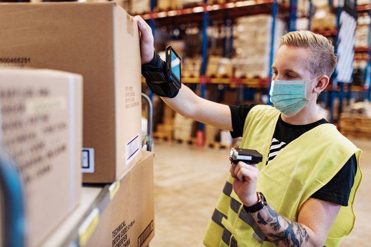 Man scanning box in warehouse